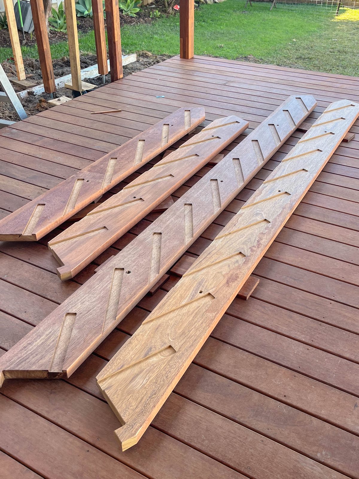 Timber stair components laid out across a deck before assembly.